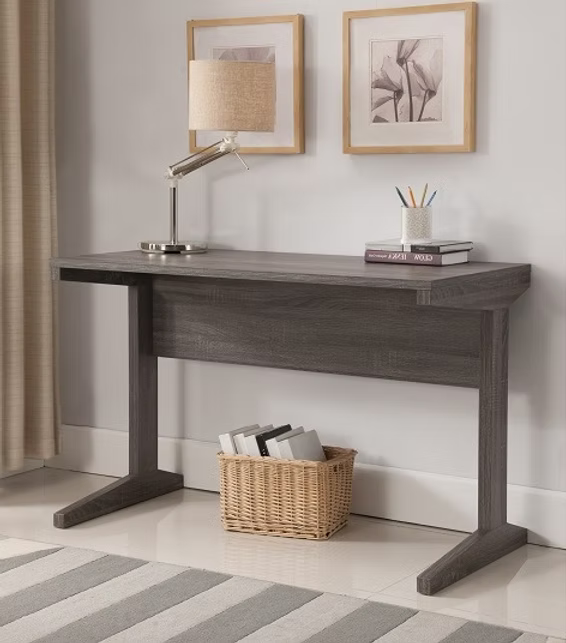 Sleek wooden office desk with a modern ergonomic setup in a bright workspace for Mode'a.
