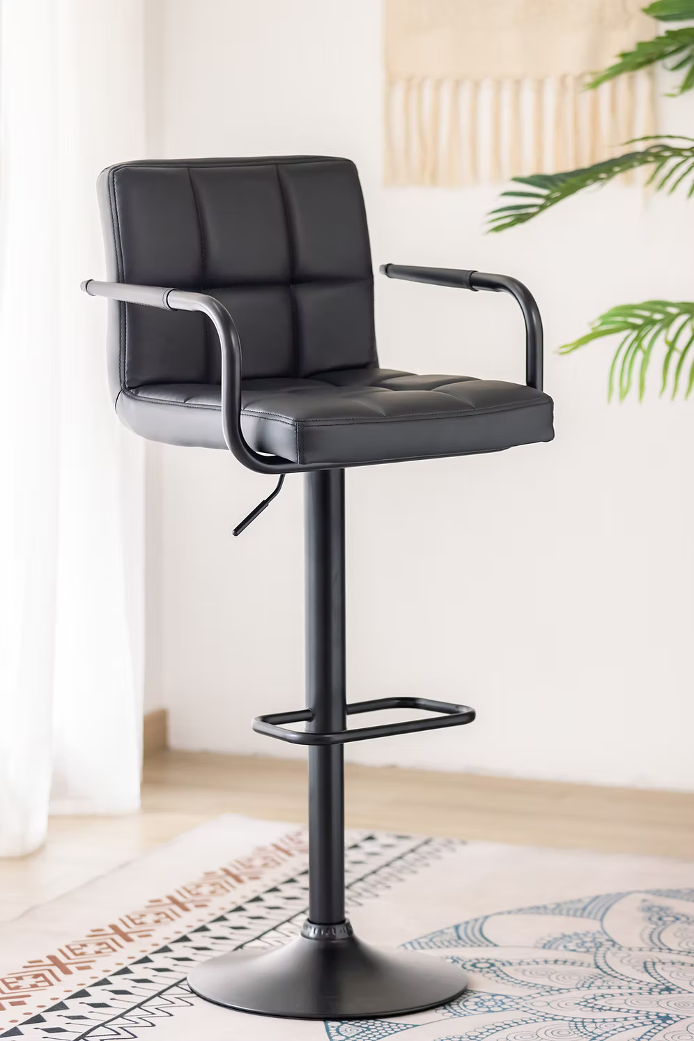 Contemporary bar stools with metal frames and comfortable seating at a modern kitchen island.