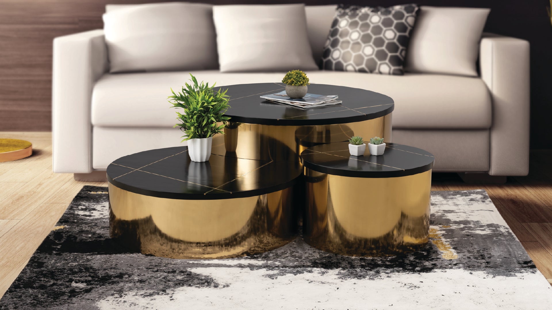 Orvani 3-piece nesting coffee table set with a circular silhouette and silver bases in a modern living room setting.