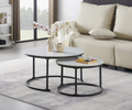 Emma modern nesting coffee table set featuring snowy white sintered stone marble tops and round black steel nested frames