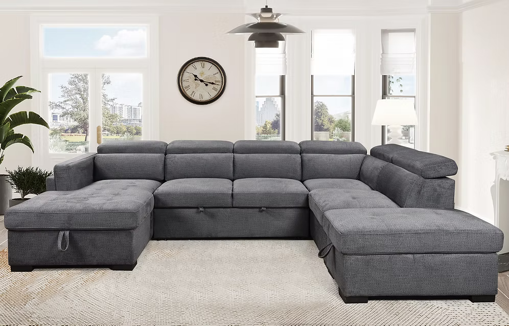 Natali modern soft grey fabric left-hand facing sectional sofa bed featuring adjustable headrests, an open bed configuration, and a lift-up storage ottoman