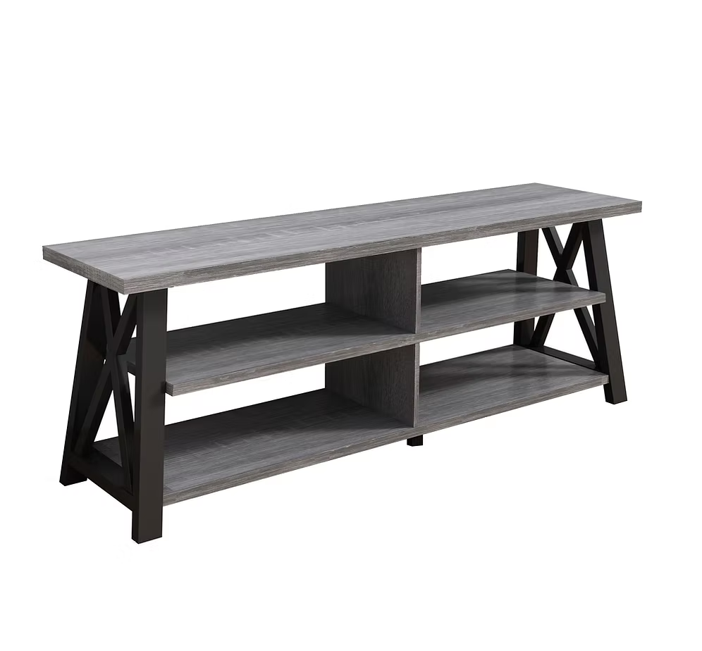Odda 71 inch modern TV stand in a distressed grey finish with rustic open shelves and black geometric X-frame side panels supporting a flat screen television