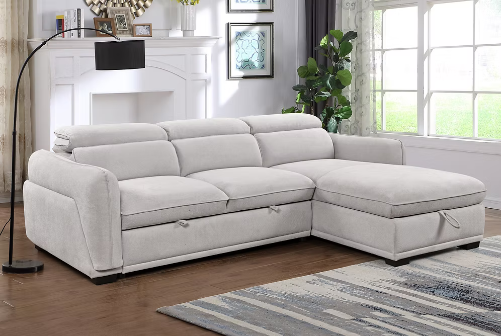 Nina modern right-hand facing sectional sofa bed in light grey fabric featuring adjustable headrests, a tufted seat design, and an open lift-up storage chaise